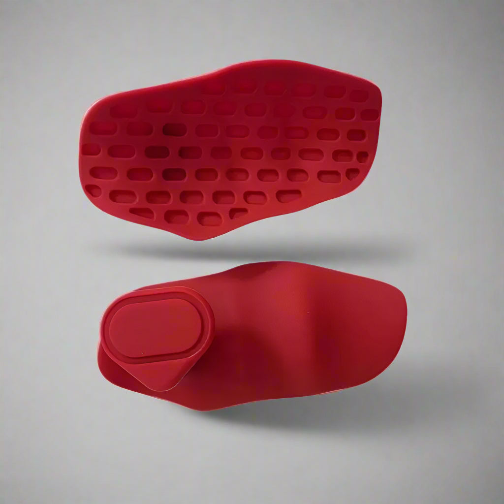 Red silicone foot pad with textured surface on a white background